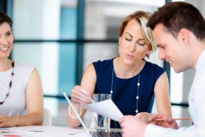 DfT Commercial professional showing contract to a colleague.