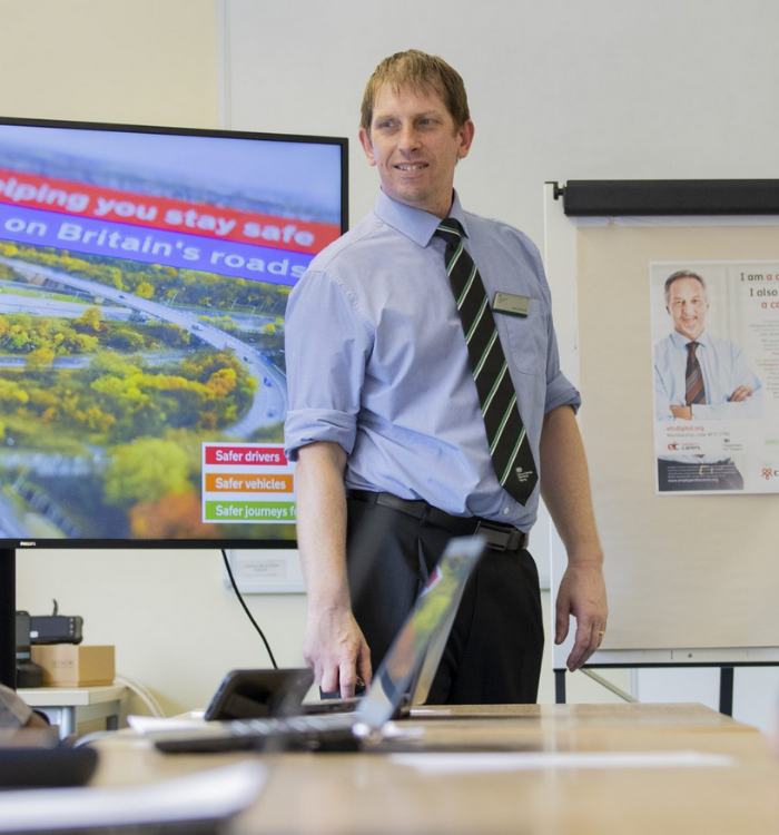 Male staff member giving a TV presentation to DVSA colleagues.