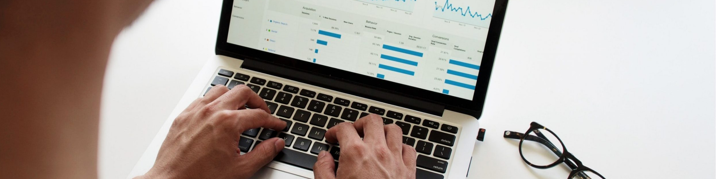 DfT Analyst studying a graph on his laptop.