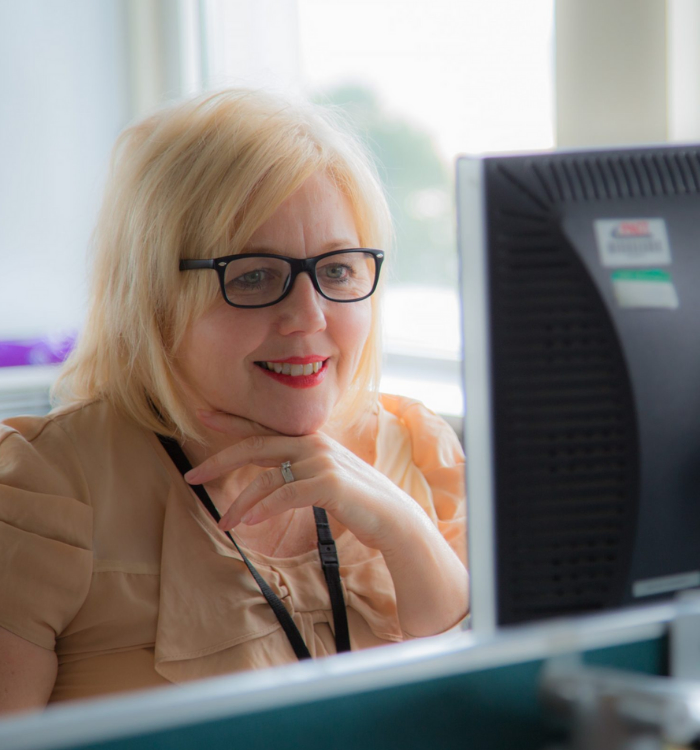 A female DVLA Commercial professional at work at her PC.