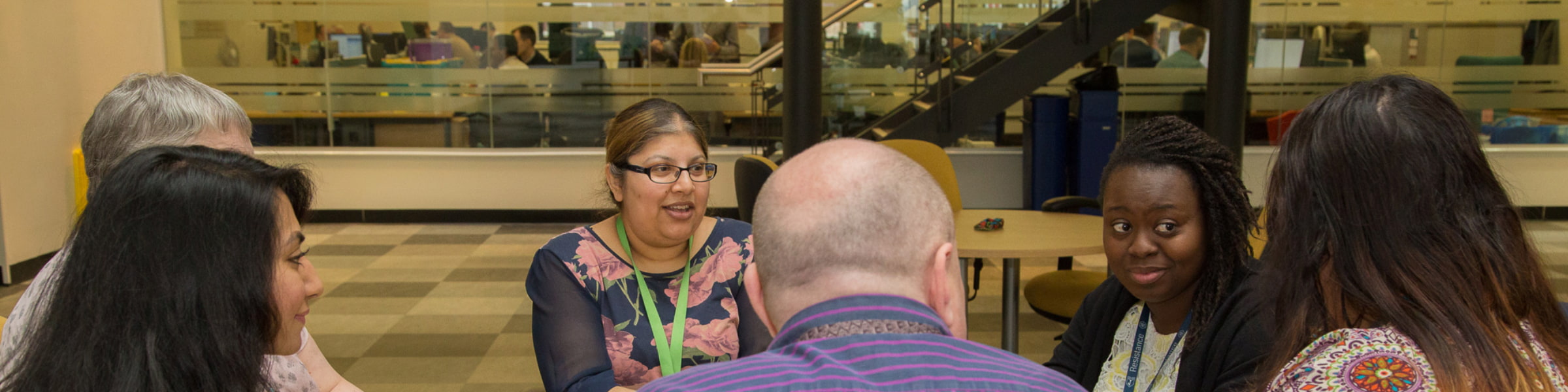 Group of DfT staff sitting around an office desk.