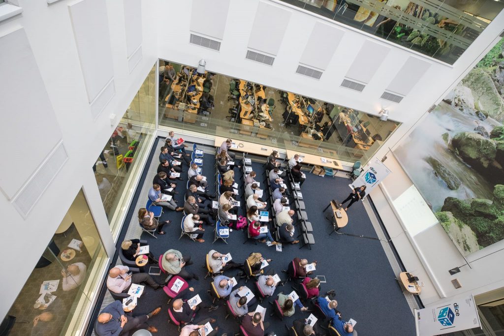 Audience listening to speaker at a learning and development event.