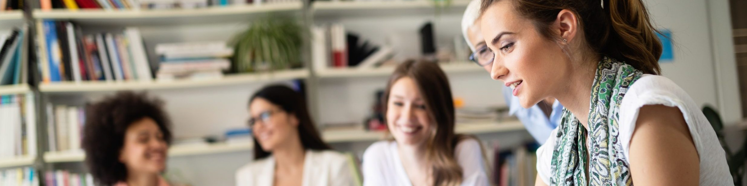 Cheerful coworkers in office during company meeting.