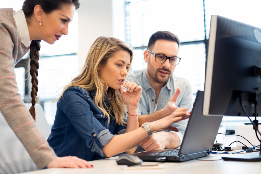 Group of Solution Architects and Software Engineers working as a team in office